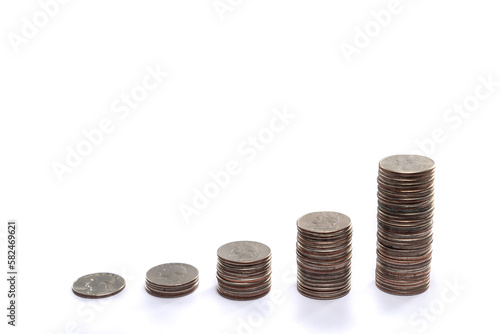 Five piles of stacked quarters with each pile of coins getting exponentially taller showing a financial savings or investment growth strategy concept isolated on a white background with copy space.