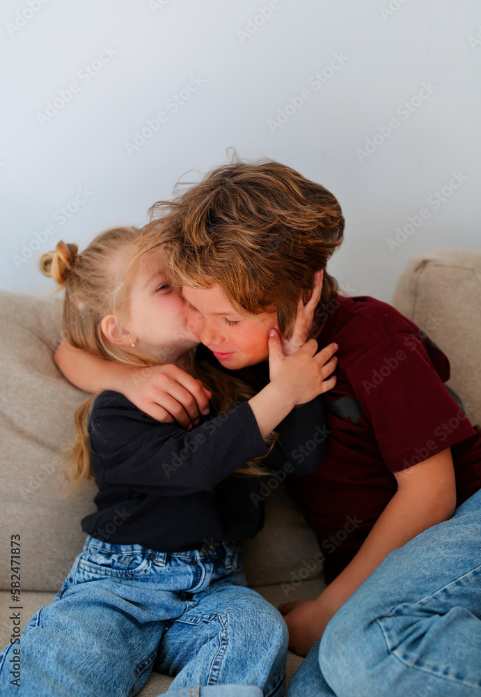Beautiful children, brother and sister, spend time together. The family is at home, they hug and have fun, laugh and play together, stylishly dressed, care, love, energy Beautiful children, brother and sister, spend time together. The family is at home, they hug and have fun, laugh and play together, stylishly dressed, care, love, energy