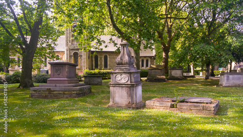 Church and tombs in the graveyard of St Pancras Old Church, London, UK.