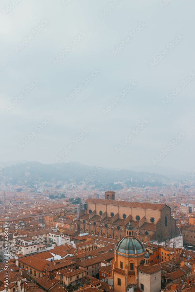Top view of terracota roofs and medieval dome in italian town