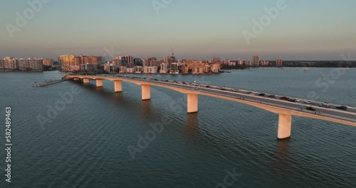 Evening aerial video of the Sarasota, Florida skyline and Ringling Parkway Bridge across Sarasota Bay	 photo