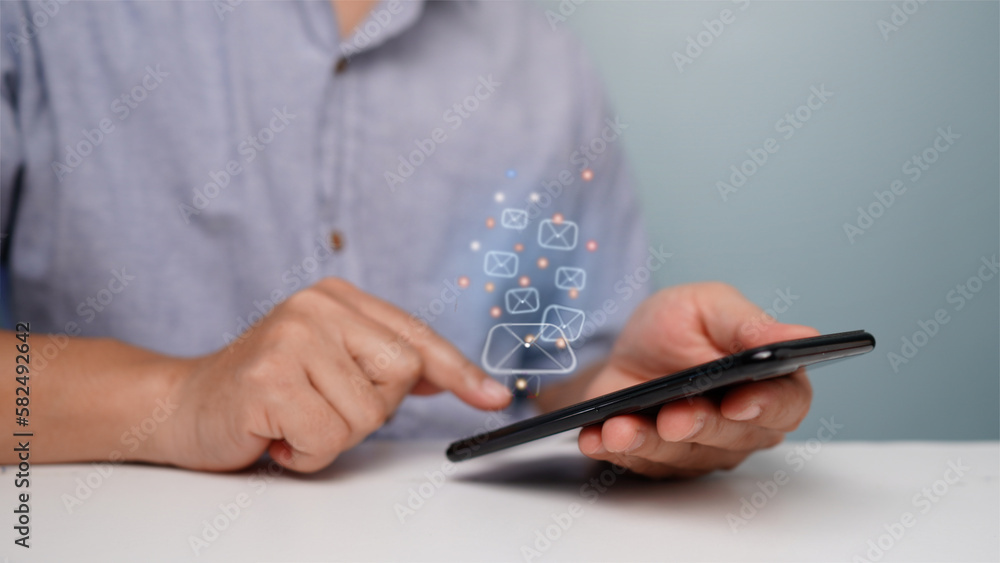 man pointing finger at smartphone on table There is an empty space on the left. (blur or berry) man pointing finger at smartphone on table There is an empty space on the left. (blur or berry)