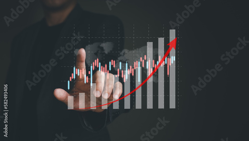 Business person point at infographic graph while analyze for interest and inflation rate that have potential growth and rising percentage with red arrow. Global economic and financial issue.