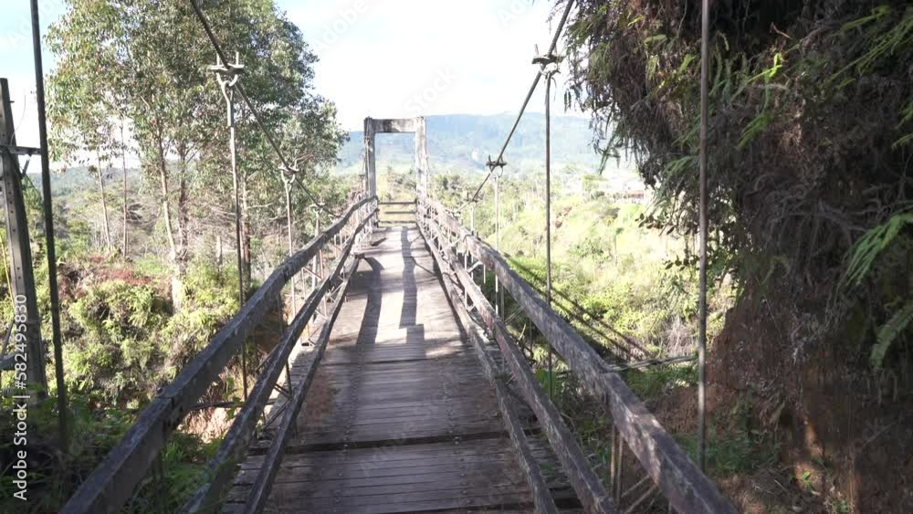 old wooden suspension bridge in the middle of the jungle and exotic nature in the mountains of colombia old wooden suspension bridge in the middle of the jungle and exotic nature in the mountains of colombia
