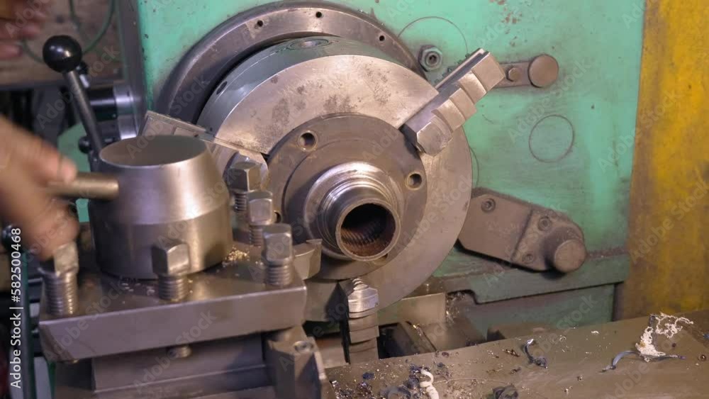 Lathe Milling Plant Metal Billet Cutting Machine with Shavings at Factory. Metalworking, industry, equipment, concept of production and metalworking. Heavy industry. Lathe Milling Plant Metal Billet Cutting Machine with Shavings at Factory. Metalworking, industry, equipment, concept of production and metalworking. Heavy industry.