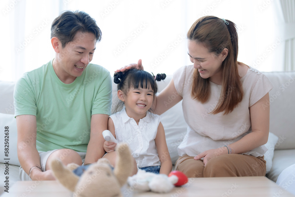 Happy Asian family spending time together in the living room at home. Happy Asian family spending time together in the living room at home.
