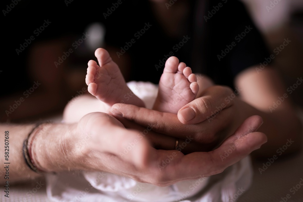 Closeup shot of a young man hugging his baby boy Closeup shot of a young man hugging his baby boy