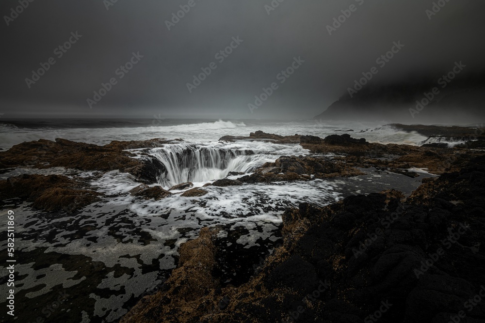 View of Thor's Well on a cloudy day. Oregon, Cape Perpetua Scenic Area, USA.