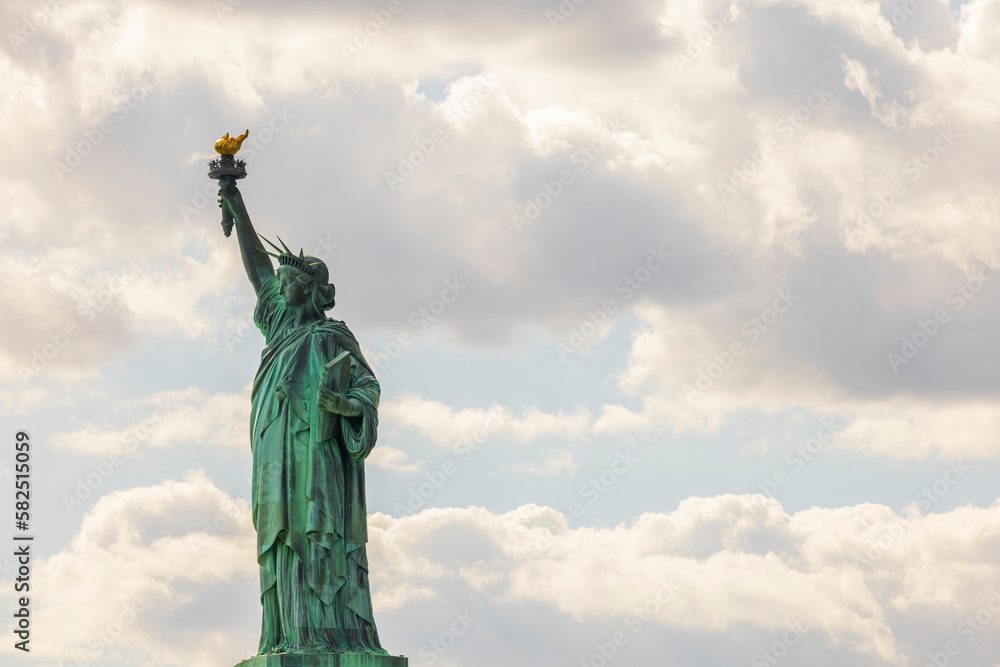 Beautiful view of famous Statue of liberty isolated on sky with white clouds background. New York, USA. 