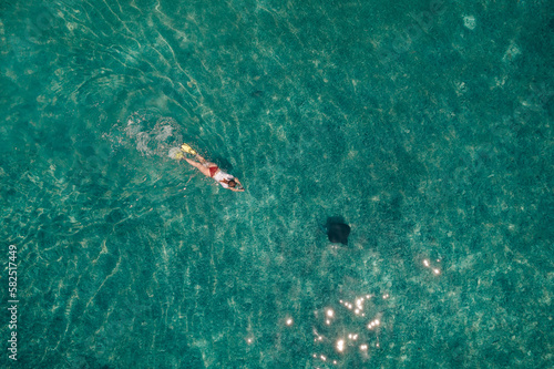 Tourists snorkeling in the waters off South Silk Cayes in the Gladden Spit and Silk Cayes Marine Reserve, Belize.