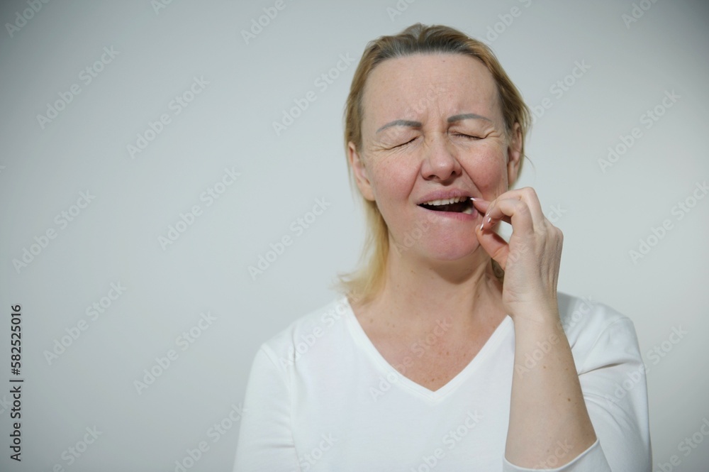 hispanic girl wearing casual clothes touching mouth with hand with painful expression because of toothache or dental illness on teeth. dentist toothache or dental illness on teeth hispanic girl wearing casual clothes touching mouth with hand with painful expression because of toothache or dental illness on teeth. dentist toothache or dental illness on teeth
