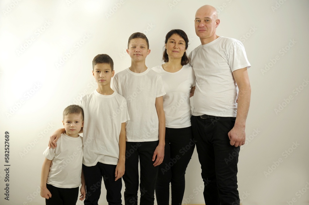 family three sons mom and dad stand together in height herringbone First small big senior And parents family three sons mom and dad stand together in height herringbone First small big senior And parents