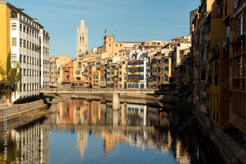 The colorful houses lining the riverbanks of Girona in Catalunya, Spain, add a picturesque charm to the city