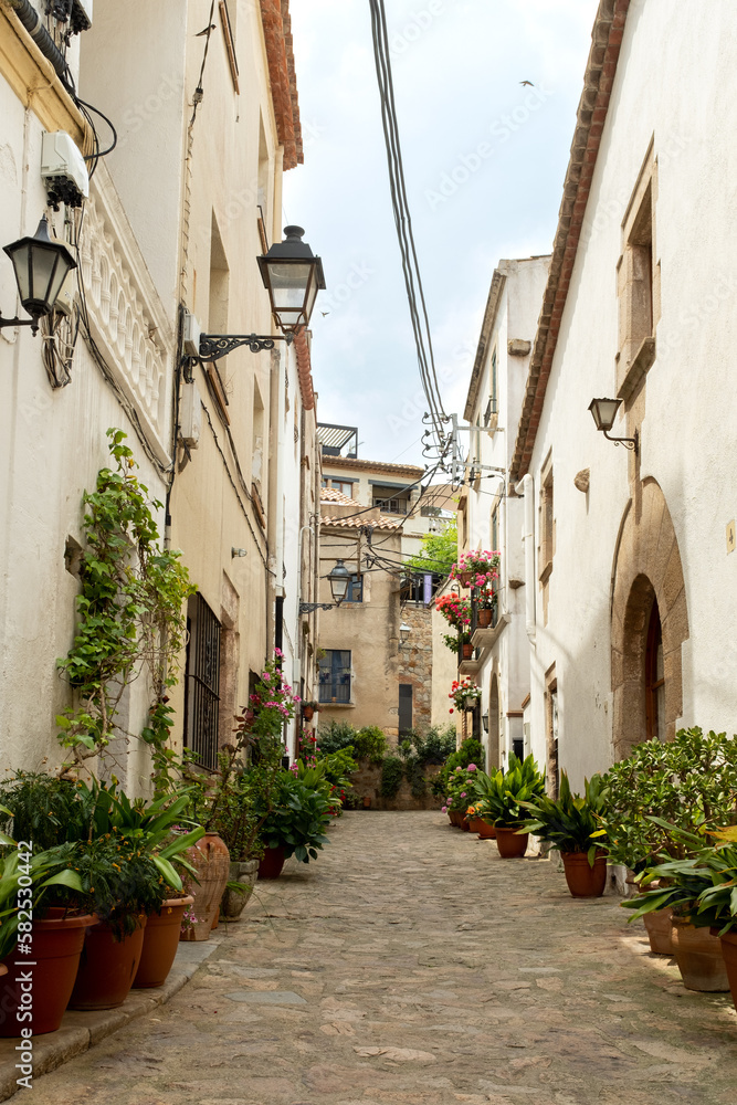 The narrow alleys of Tossa de Mar, Spain, lead to hidden courtyards and picturesque squares..
