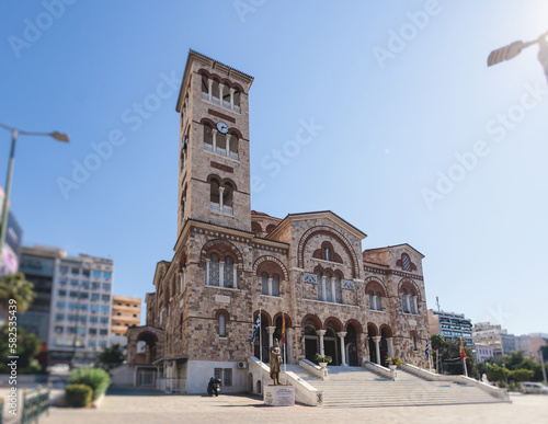 Fototapeta Naklejka Na Ścianę i Meble -  Hagia Triada neo-byzantine Cathedral facade exterior in Piraeus, Holy Trinity Greek Orthodox church, Piraeus city street view, Attica, Greece, summer sunny day with a blue sky
