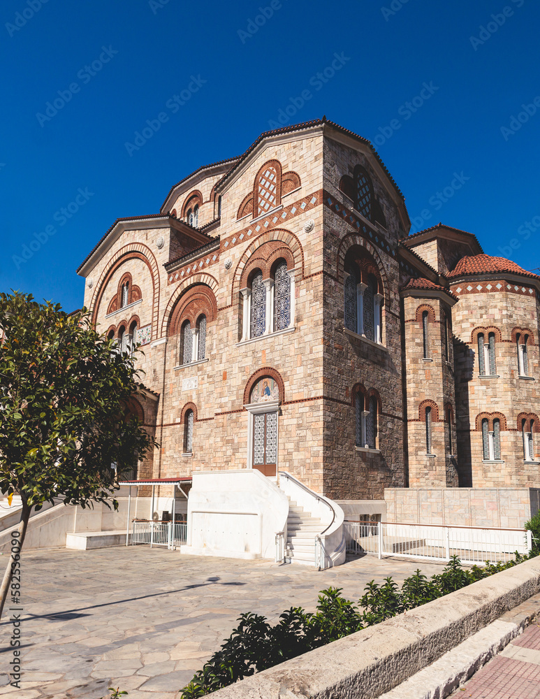 Hagia Triada neo-byzantine Cathedral facade exterior in Piraeus, Holy Trinity Greek Orthodox church, Piraeus city street view, Attica, Greece, summer sunny day with a blue sky