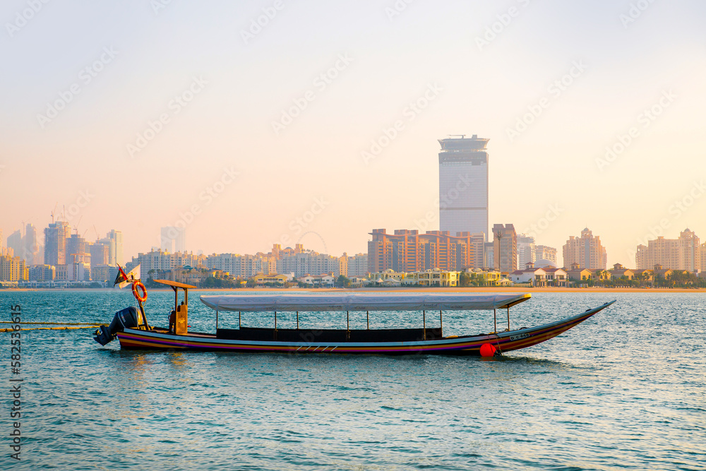 Dubai, UAE. Tourists boat at Palm Jumeirah  at sunset