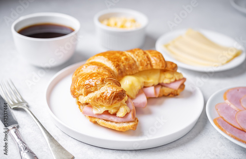 Ham cheese scrambled eggs croissant for breakfast