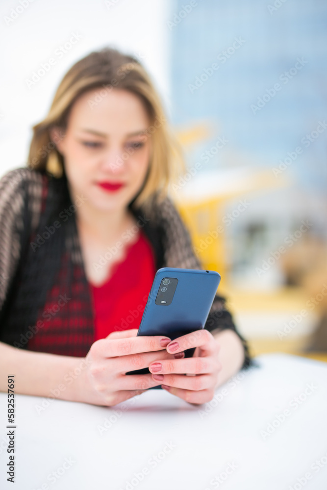 Happy woman calling on phone on a coffee shop Happy woman calling on phone on a coffee shop