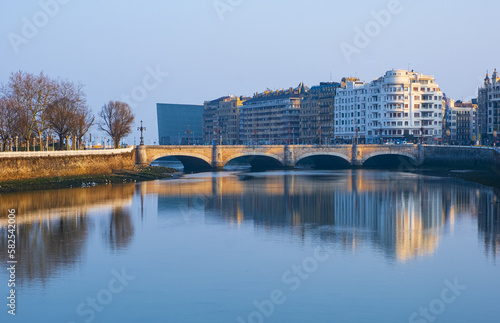 The city of Donostia-San Sebastian is reflected in the Urumea River at dawn. photo