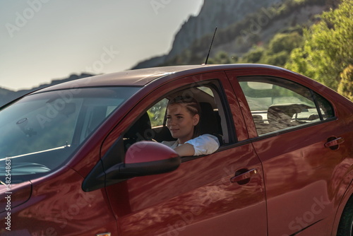 Woman driving a car. A lady in sunglasses takes the wheel of her © svetograph