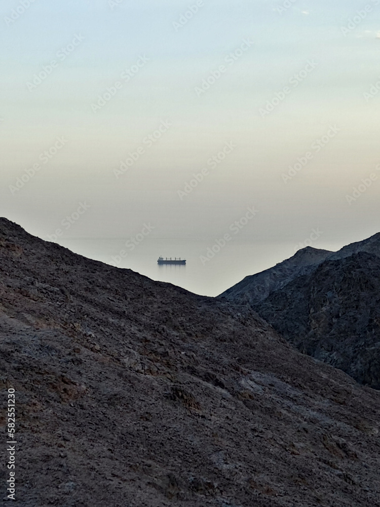 ship at sea through the mountains