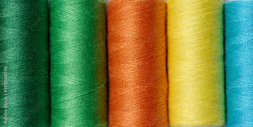 Multicolored spools of sewing threads Multicolored spools of sewing threads