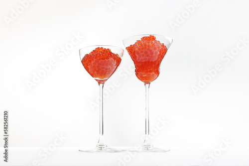 The caviar is red. Glass wine glasses filled with red caviar, salmon caviar. Delicatessen store. Gourmet food, delicious food concept, selective focus, place for text.