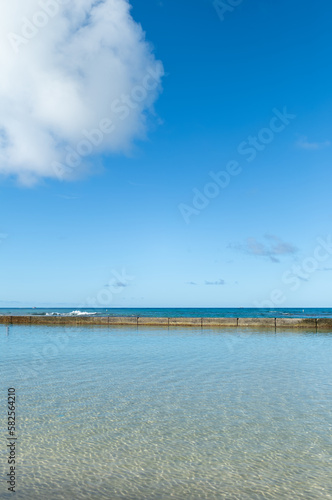 Empty Beach and Sky with a White Cumulus Cloud.