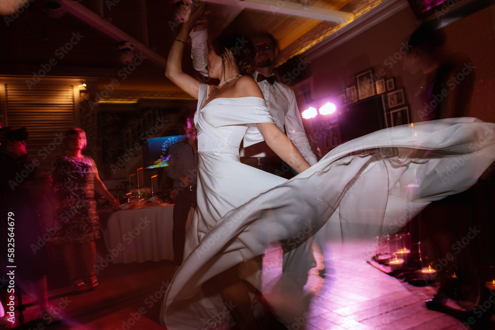 the first dance of the bride and groom inside a restaurant