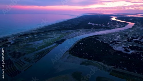 Landscape at sunset. Aerial view from a drone of the landscape of marshes and salt flats of the Ria Formosa Natural Park. Atlantic Ocean. Algarve. Portugal. Europe