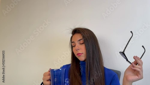 Happy woman drinking at the office. Woman thinking
