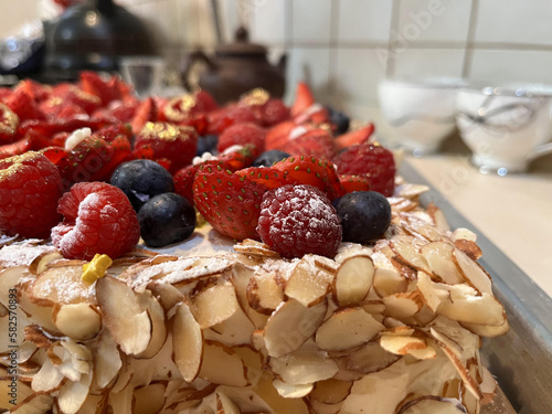 Selective focus of wild berries on a cake close-up. Sweet dessert.