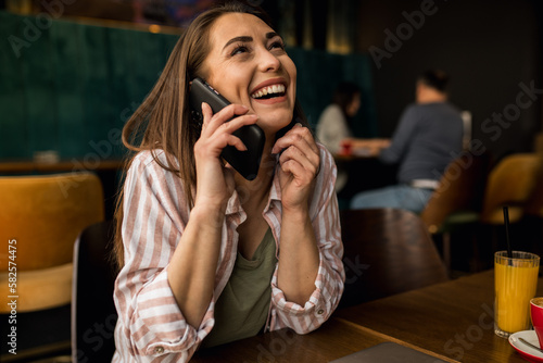 Woman talking on the phone in a busy restaurant