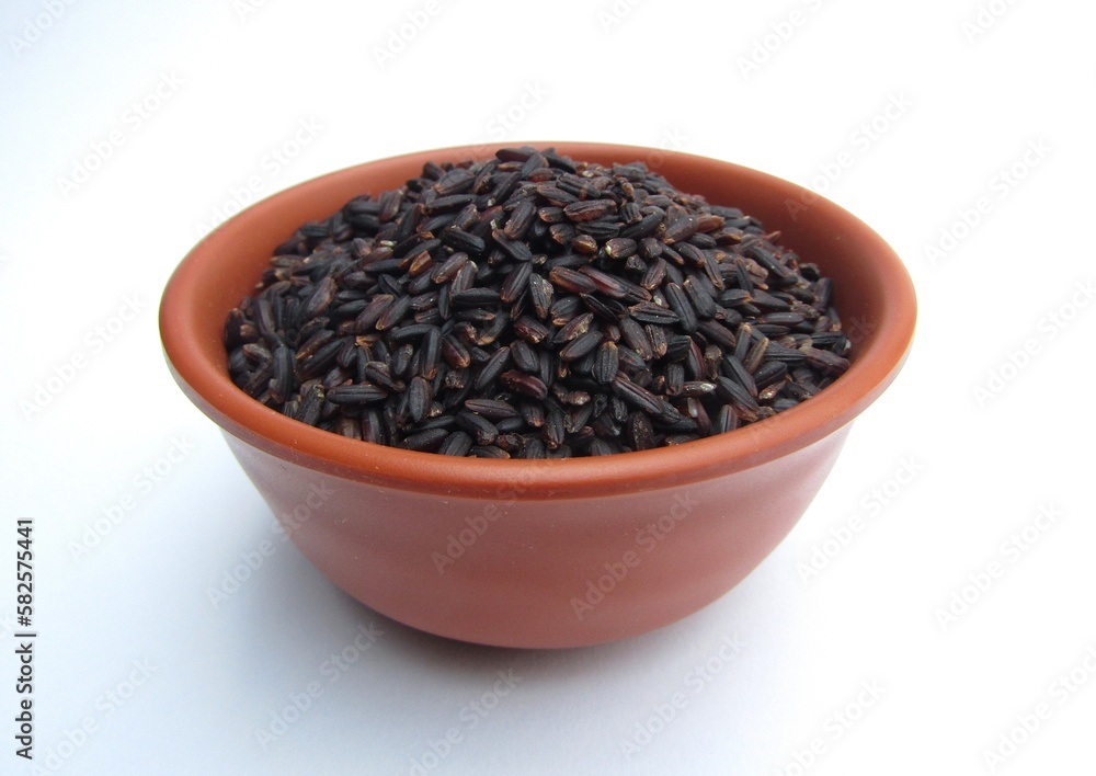 Black rice in a bowl on white background Black rice in a bowl on white background