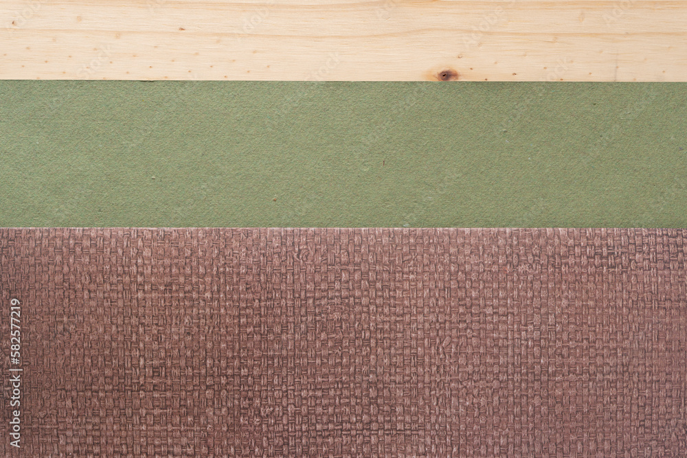 Fototapeta premium folded scrapbook paper with pattern and rough green paper on wood plank