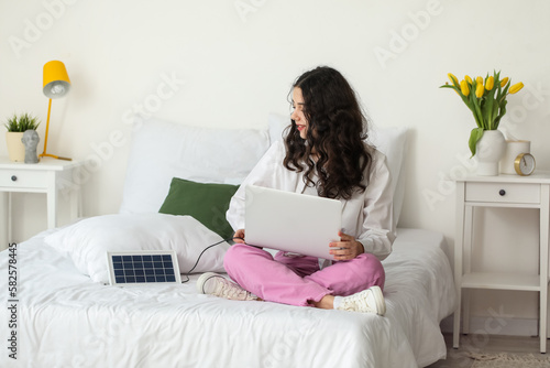 Teenage girl using laptop c...