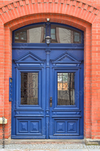 View of brick building with blue wooden door