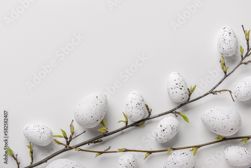 Composition with plant branches and Easter eggs on light background