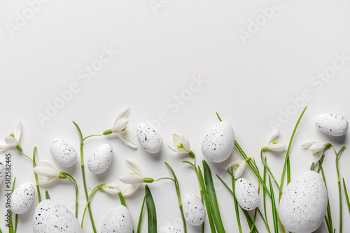 Canvas Print Composition with Easter eggs and beautiful snowdrops on light background, closeu