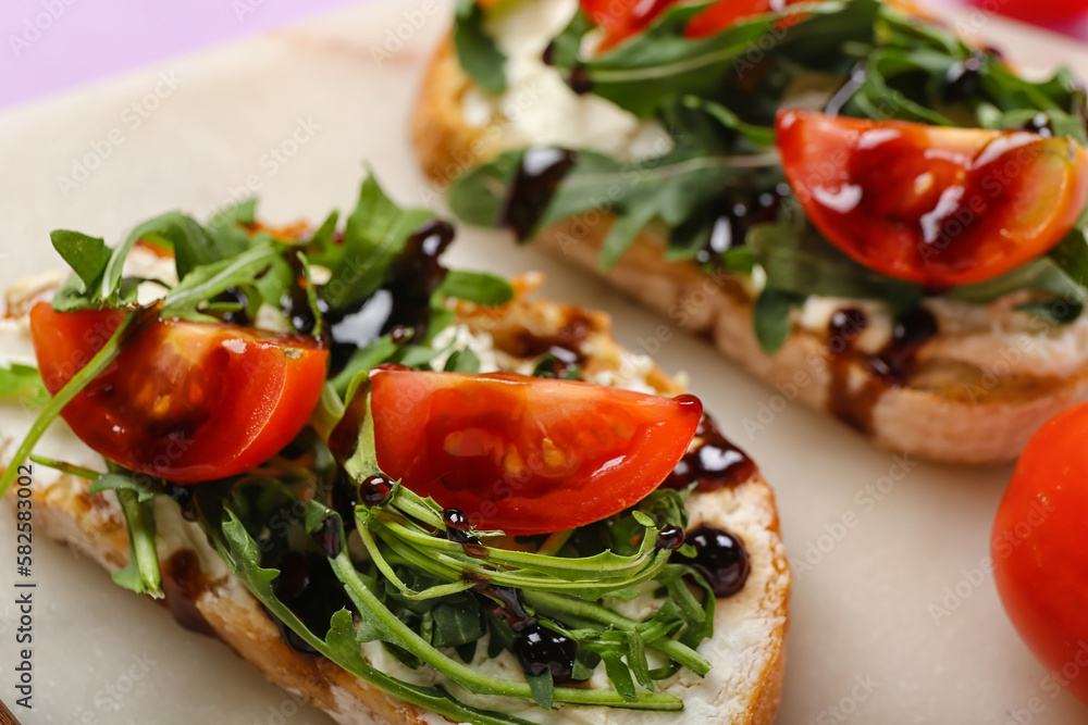 Board of tasty sandwiches with cream cheese, arugula and tomatoes, closeup Board of tasty sandwiches with cream cheese, arugula and tomatoes, closeup