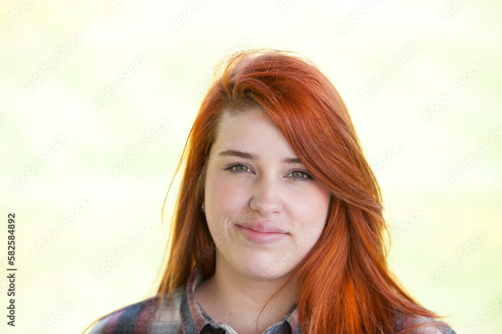 Outdoor portrait of young red haired woman. Outdoor portrait of young red haired woman.