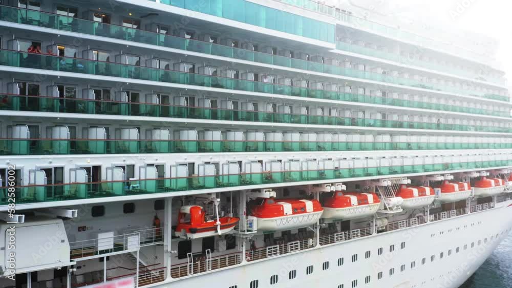Aerial side view of cabins and lifeboats on a cruise ship moored at the pier Aerial side view of cabins and lifeboats on a cruise ship moored at the pier