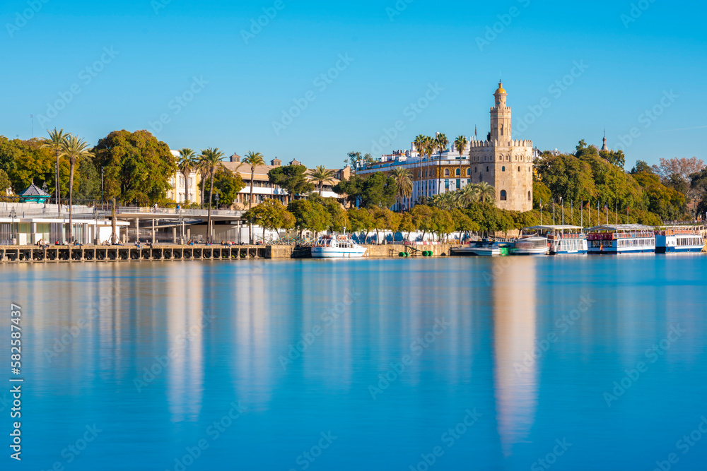 Long exposure of Guadalquivir River from Triana with the Torre del Oro and seville in the background