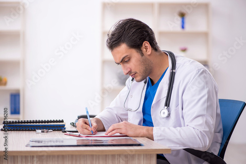 Young male doctor working in the clinic