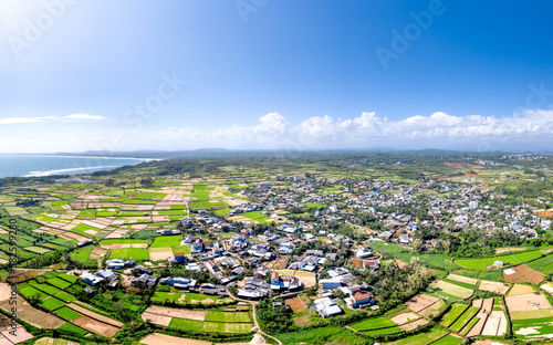 Fototapeta Naklejka Na Ścianę i Meble -  A panoramic view of the fields by the sea in Tinh Khe commune, Binh Son district, Quang Ngai province, Vietnam. View from above