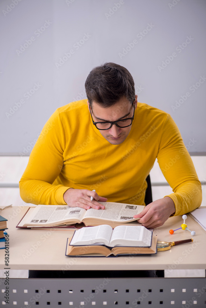 Young male student sitting in the classroom Young male student sitting in the classroom