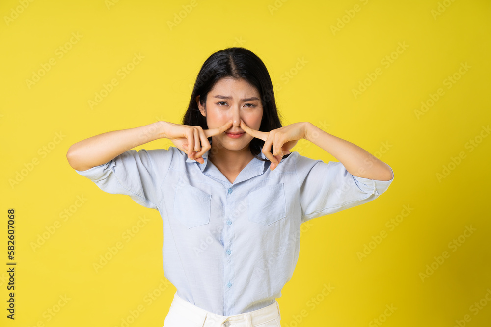portrait of beautiful asian girl posing on yellow background portrait of beautiful asian girl posing on yellow background