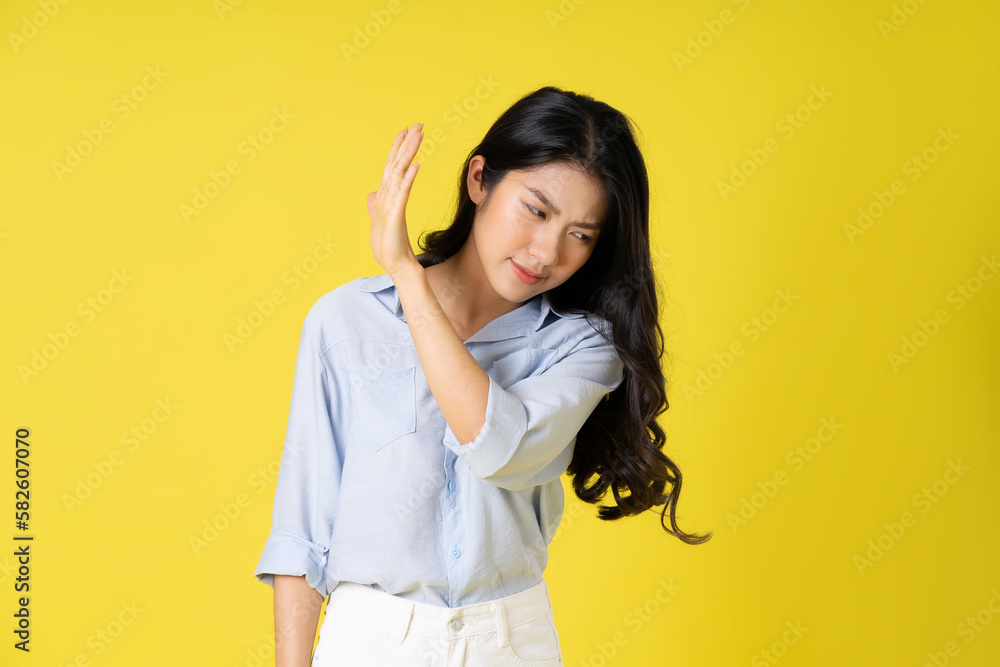 portrait of beautiful asian girl posing on yellow background portrait of beautiful asian girl posing on yellow background