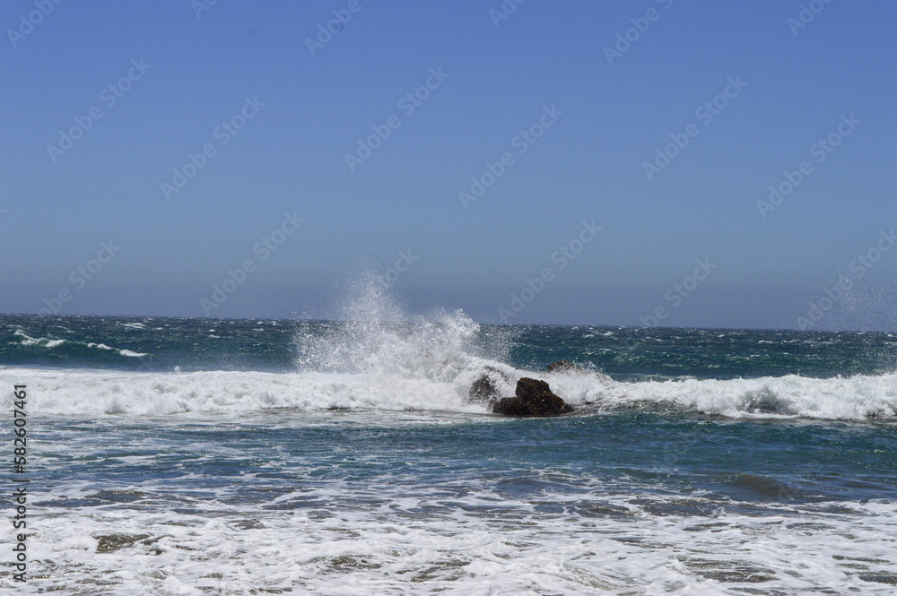 wave splashing on rock